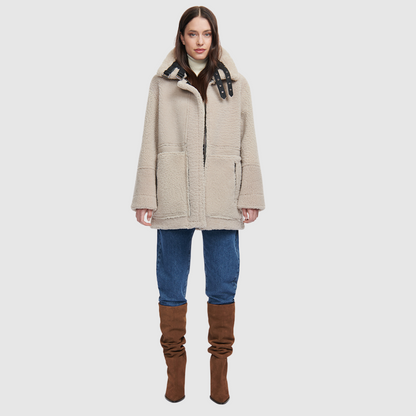 Nappa curly wool shearling Reversible relaxed medium length nappa moto Reverses to curly wool teddy  Drop shoulder Curly wool collar and trims Straight fit  Patch pockets on both skin-out and reversed wool-out sides Front zip closure 