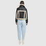 This cropped biker jacket is updated with contrasting wool seams. Crafted in genuine shearling, the jacket is finished with zip pockets and buckle accents at the collar and cuffs. Genuine Shearling Spread collar Long-sleeve Zipper closure Imported