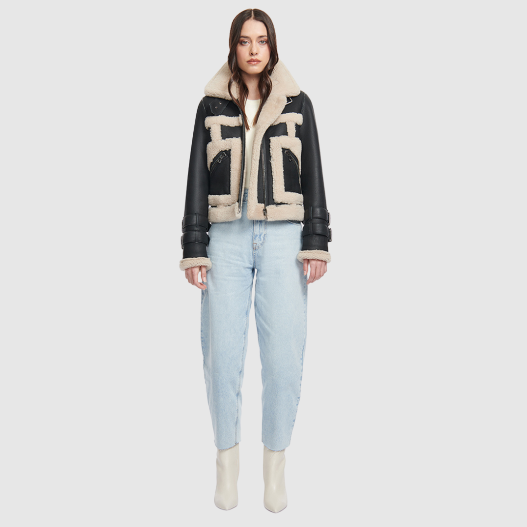This cropped biker jacket is updated with contrasting wool seams. Crafted in genuine shearling, the jacket is finished with zip pockets and buckle accents at the collar and cuffs. Genuine Shearling Spread collar Long-sleeve Zipper closure Imported