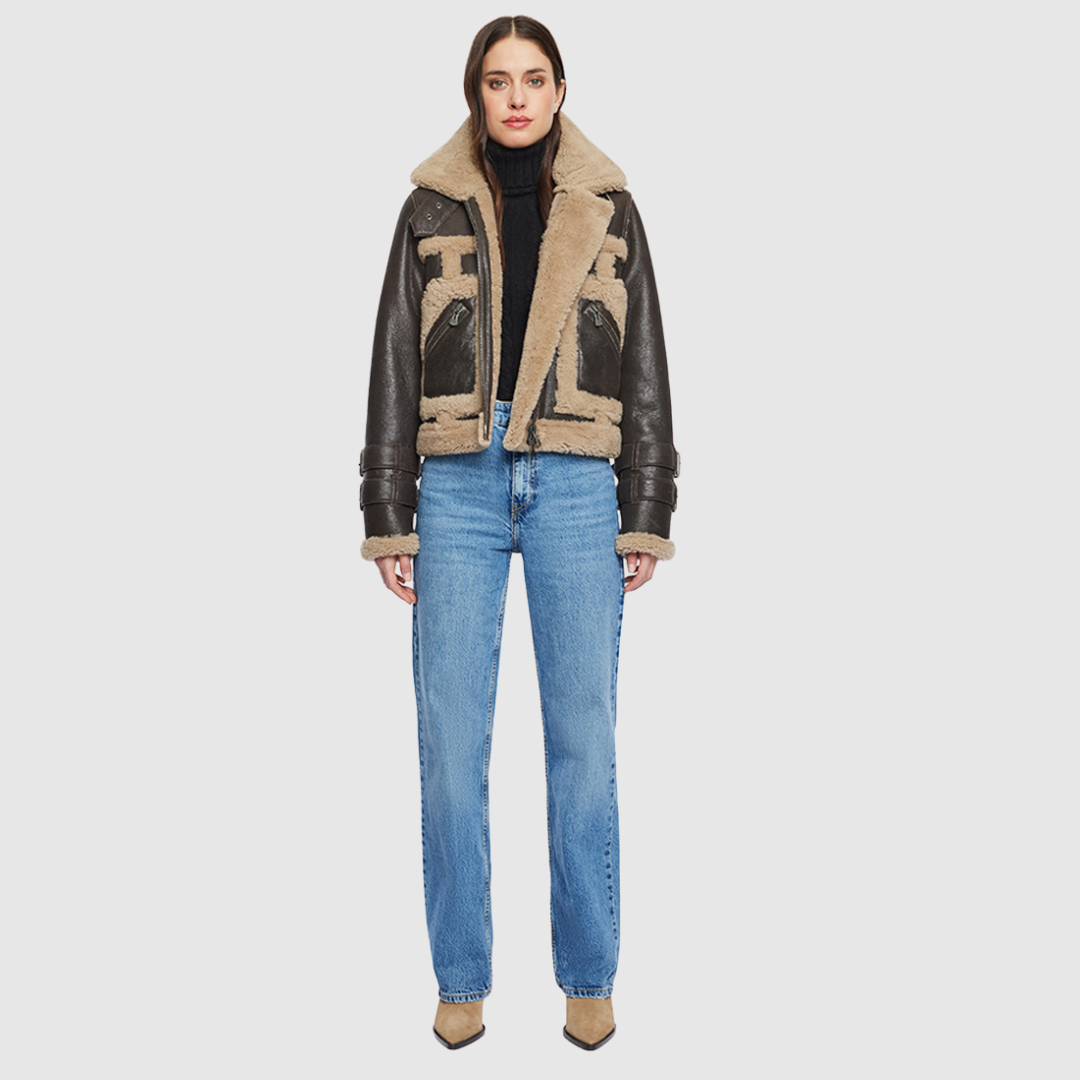 This cropped biker jacket is updated with contrasting wool seams. Crafted in genuine shearling, the jacket is finished with zip pockets and buckle accents at the collar and cuffs. Genuine Shearling Spread collar Long-sleeve Zipper closure Imported