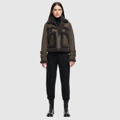 This cropped biker jacket is updated with contrasting wool seams. Crafted in genuine shearling, the jacket is finished with zip pockets and buckle accents at the collar and cuffs. Genuine Shearling Spread collar Long-sleeve Zipper closure Imported