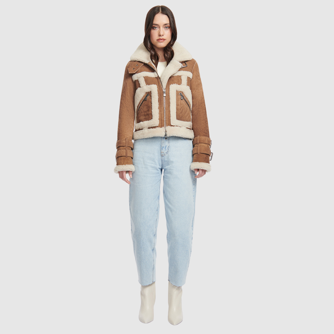 This cropped biker jacket is updated with contrasting wool seams. Crafted in genuine shearling, the jacket is finished with zip pockets and buckle accents at the collar and cuffs. Genuine Shearling Spread collar Long-sleeve Zipper closure Imported