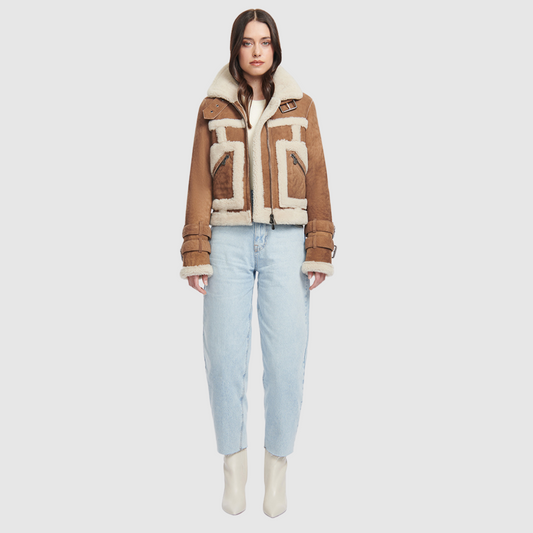 This cropped biker jacket is updated with contrasting wool seams. Crafted in genuine shearling, the jacket is finished with zip pockets and buckle accents at the collar and cuffs. Genuine Shearling Spread collar Long-sleeve Zipper closure Imported