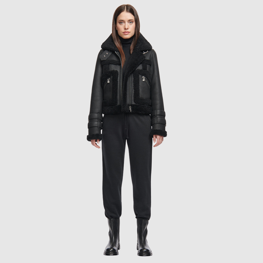 This cropped biker jacket is updated with contrasting wool seams. Crafted in genuine shearling, the jacket is finished with zip pockets and buckle accents at the collar and cuffs. Genuine Shearling Spread collar Long-sleeve Zipper closure Imported