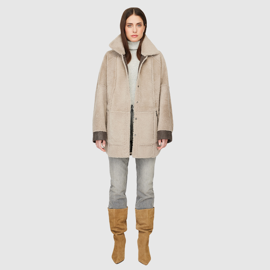 Reversible oversized nappa shacket Reverses to curly wool teddy Contrast curly wool seams on nappa side Drop shoulder Relaxed fit through shoulders, arms and torso Curly wool spread collar Side patch pockets on nappa side Side zip pockets on curly wool side Front snap closure 