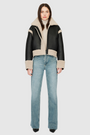 Reversible oversized cropped jacket curly wool and nappa combination Drop shoulder Tapered at hem Standard front zip closure Side and interior zip pockets