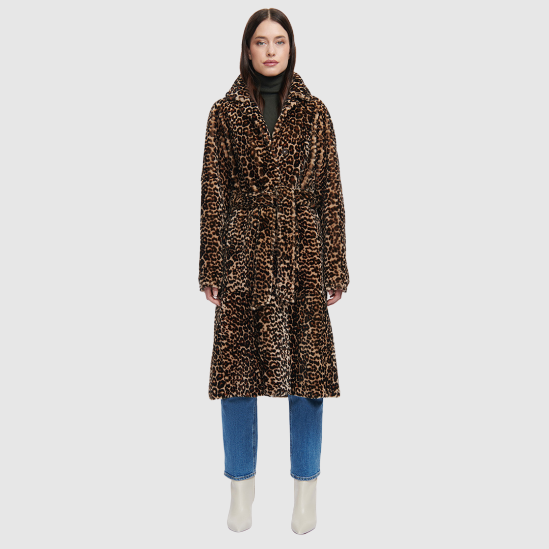 The HARLEY Shearling Coat brings a bold twist to classic outerwear with its striking snow leopard print in plush mouton wool. Cut to a knee length with a fitted A-line silhouette, it offers a flattering shape while delivering heritage-level warmth. A notch collar and clean three-button front with a tie wrap closure add refined structure, while slash pockets provide everyday practicality. Designed for those who favor statement outerwear, HARLEY blends après-ski glamour with timeless sophistication.
