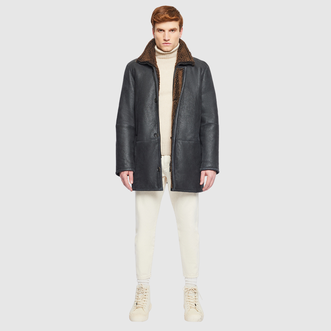 The Jakos Macassar Shearling Jacket is a sleek, contemporary take on a classic shearling coat. Crafted from nappa leather with a curly wool interior, it features a zippered stand collar and a two-way front zip closure concealed by a buttoned placket. Straight-cut through the torso with a regular fit, Jakos combines tailored structure with everyday versatility. Interior and exterior pockets provide functional storage without compromising its clean silhouette.