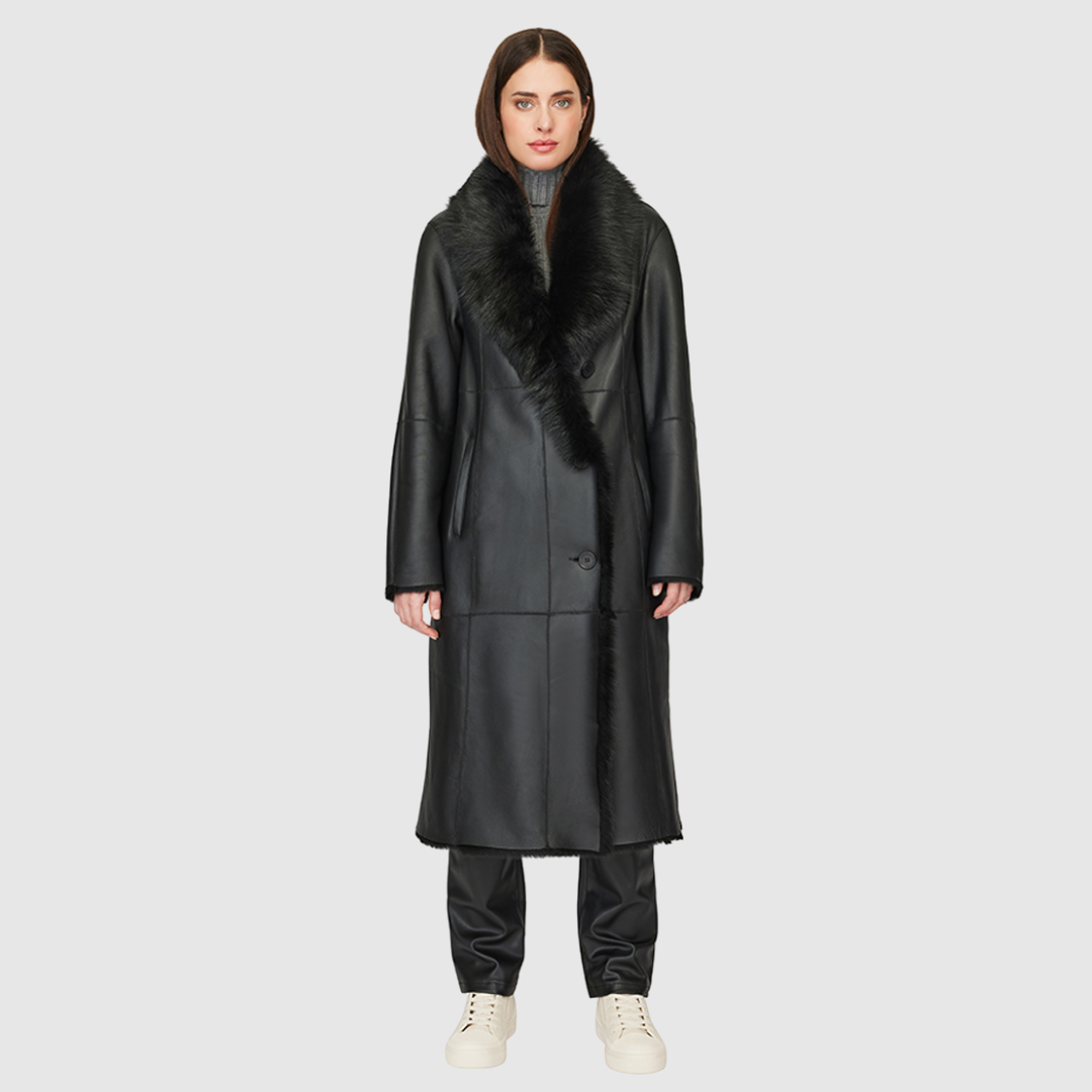 The Libra Jet Silky Shearling Coat combines luxurious nappa with Toscana rasado shearling for a contemporary parka-inspired design. Featuring an oversized shawl collar and raw-edge hem, this coat delivers a relaxed silhouette with subtle structure. Slight drop shoulders and a roomy fit through the arms and torso enhance ease of movement, while single welt side pockets and an interior zip pocket provide functional elegance. Finished with a four-button front closure