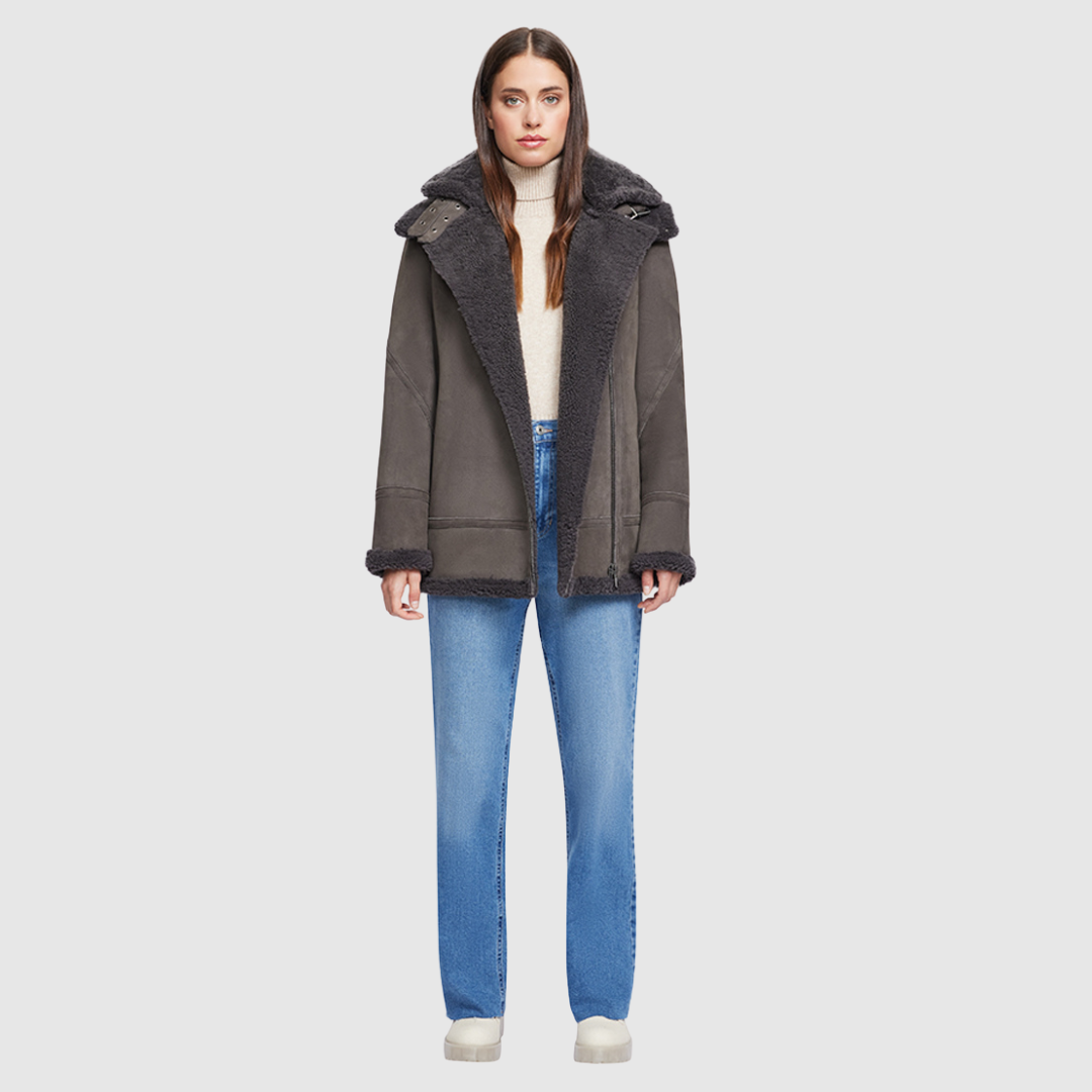 Expertly crafted with a suede exterior, this moto jacket boasts a relaxed fit and medium length for added comfort. The luxurious shearling collar and trims perfectly complement the drop shoulder design, while the detachable hood offers versatility. With an asymmetrical front zip closure, exterior zip pockets, and hidden inside pockets, this jacket is both stylish and functional.