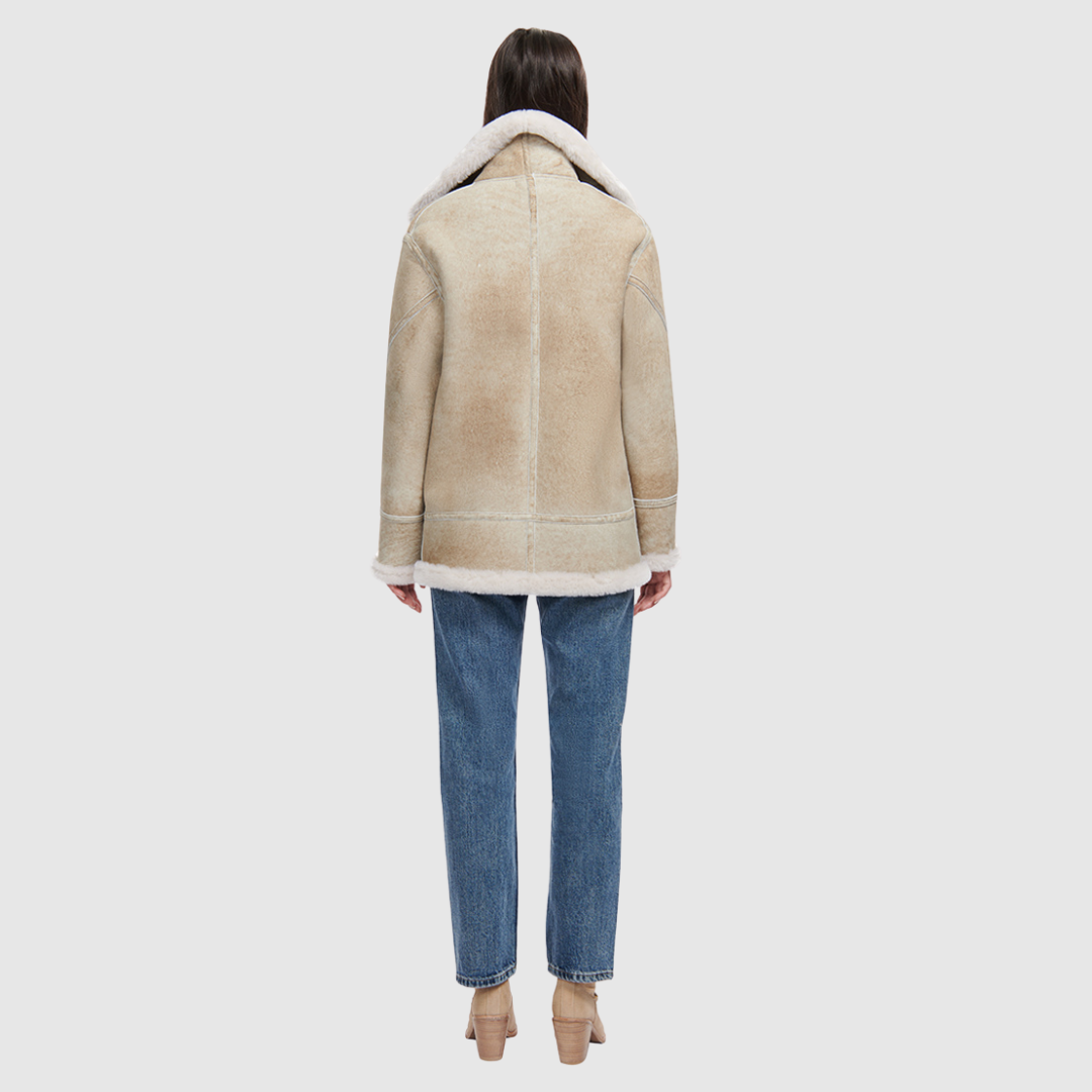 Suede relaxed medium length moto Ironed wool collar and trims Drop shoulder Detachable hood Asymmetrical front zip closure Exterior zip pockets Hidden inside pockets
