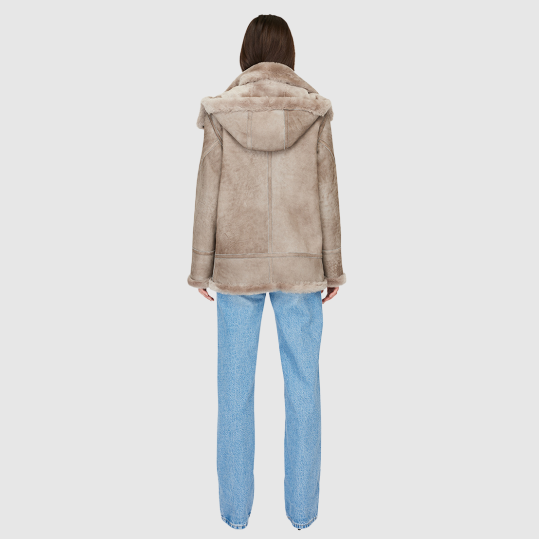 Suede relaxed medium length moto Ironed wool collar and trims Drop shoulder Detachable hood Asymmetrical front zip closure Exterior zip pockets Hidden inside pockets