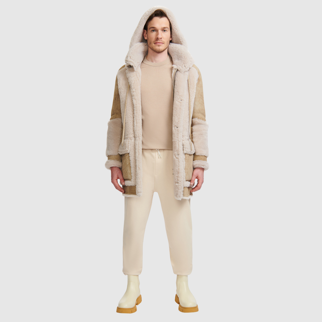 The Octavian Cement Shearling Parka is a modern mixed-media outerwear piece designed for versatility and functionality. Crafted with contrast curly wool exterior detailing and a removable hood, it features a slightly oversized fit with a regular shoulder for ease of movement. Oversized patch pockets and a front zip closure combine practicality with contemporary style, making it a cold-weather essential.