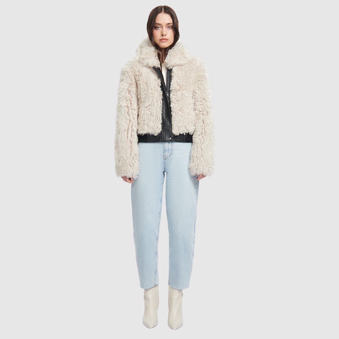 This HiSO Parma Parchment Shearling Bomber boasts a stylish design with a drop shoulder and Nappa leather trims. Made with curly toscana wool-out material, it features slash side pockets and a front zip and button closure for convenience and functionality.