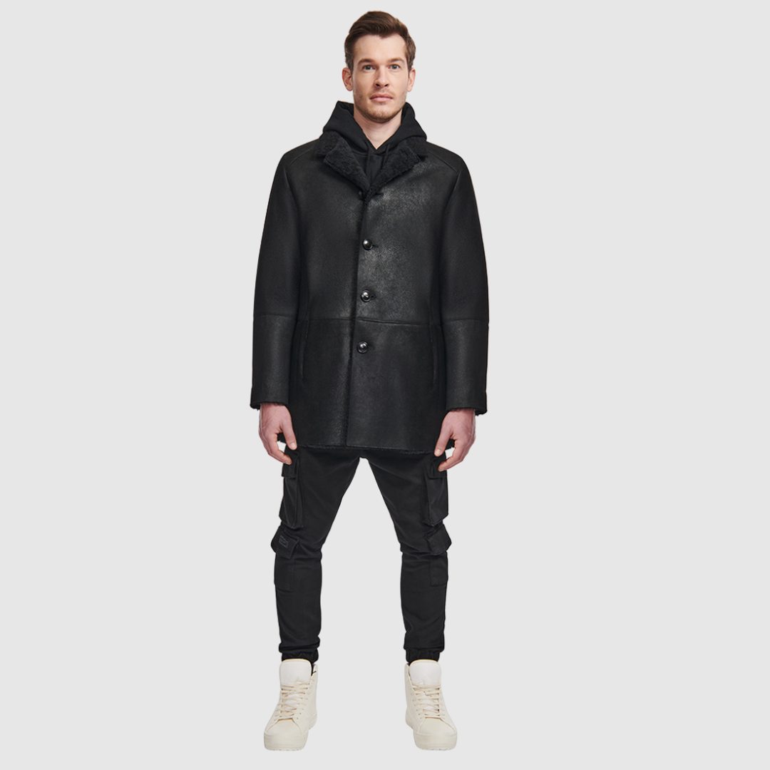 The Royce Jet Shearling Jacket is a refined take on classic outerwear, crafted from ultra-light suede with a rich curly wool interior. Its single-breasted silhouette and stand collar with a short lapel create a clean, timeless profile, while a button closure ensures understated polish. Designed in a regular fit, this jacket offers both comfort and elevated versatility for everyday wear.