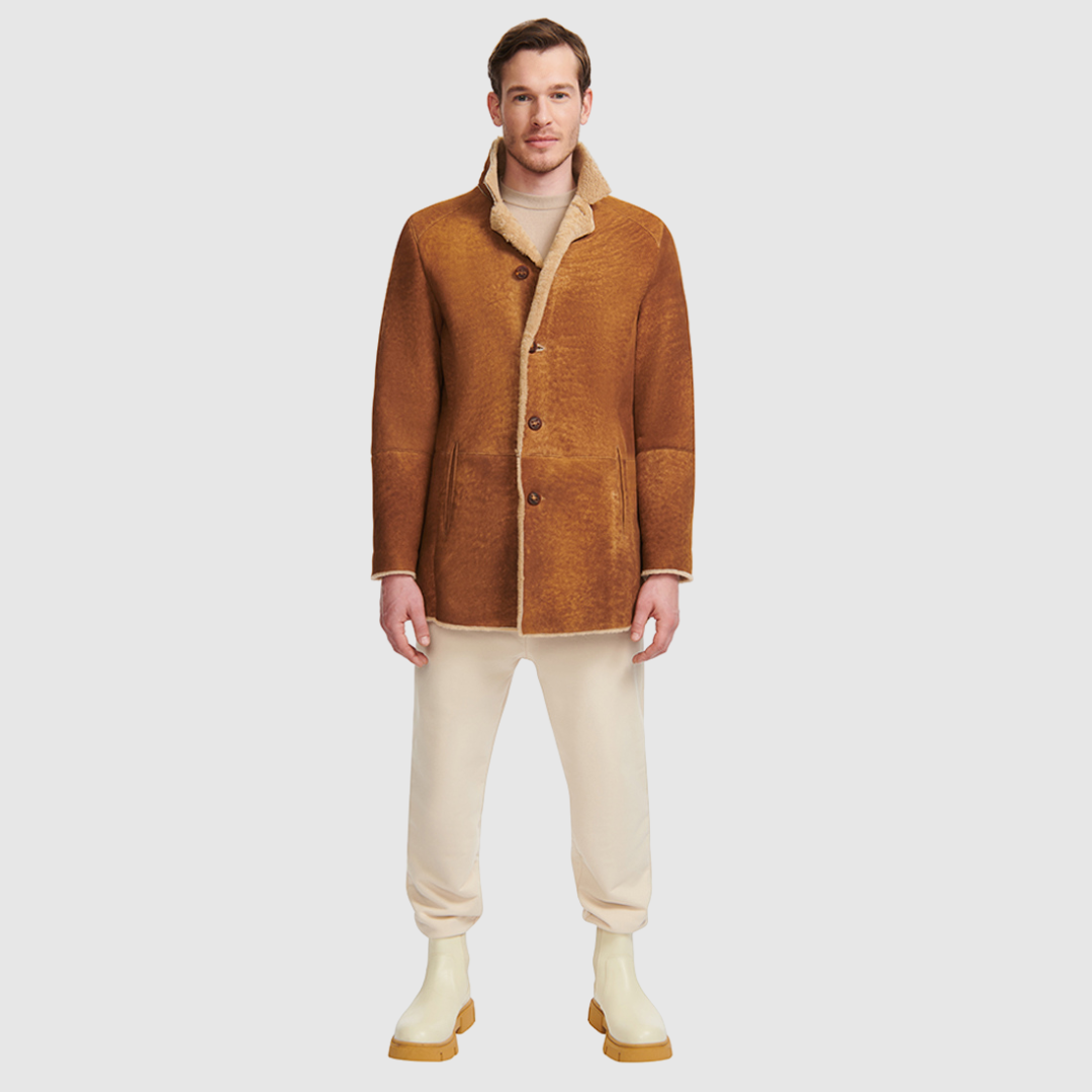  The Royce Toffee Shearling is a refined take on classic outerwear, crafted from ultra-light suede with a rich curly wool interior. Its single-breasted silhouette and stand collar with a short lapel create a clean, timeless profile, while a button closure ensures understated polish. Designed in a regular fit, this jacket offers both comfort and elevated versatility for everyday wear.