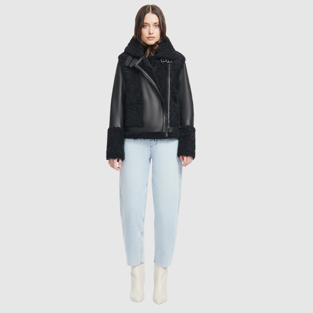 This sleek moto is designed with a high stand collar with double buckle detail and an asymmetrical front zip closure. Crafted in genuine shearling, the jacket is finished with side zip pockets and an interior pocket.
