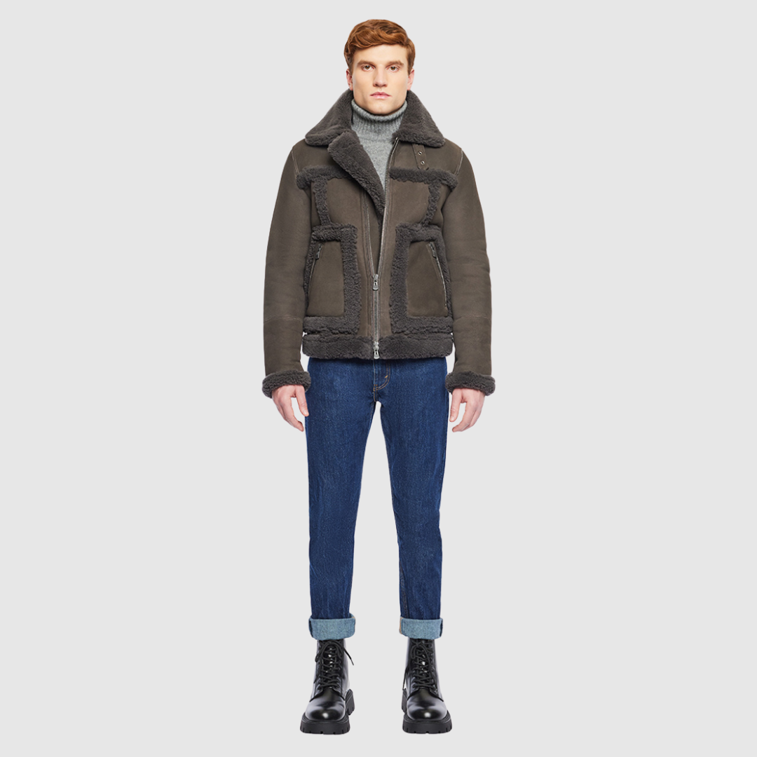 The Umberto Cappuccino Shearling Jacket combines mixed-media suede construction with luxe curly wool detailing for a contemporary twist on classic outerwear. Designed with a regular shoulder and a comfortable fit through the shoulders and chest, it features contrast curly wool seam details and a spread collar with buckle accents. Side zip patch pockets and a front zip closure offer both functionality and refined design.