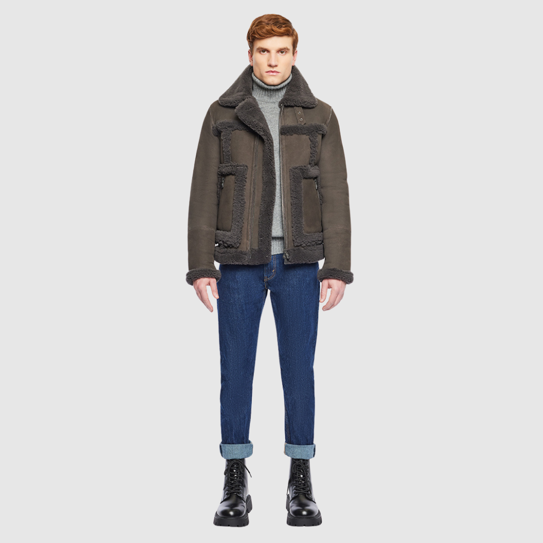 The Umberto Cappuccino Shearling Jacket combines mixed-media suede construction with luxe curly wool detailing for a contemporary twist on classic outerwear. Designed with a regular shoulder and a comfortable fit through the shoulders and chest, it features contrast curly wool seam details and a spread collar with buckle accents. Side zip patch pockets and a front zip closure offer both functionality and refined design.