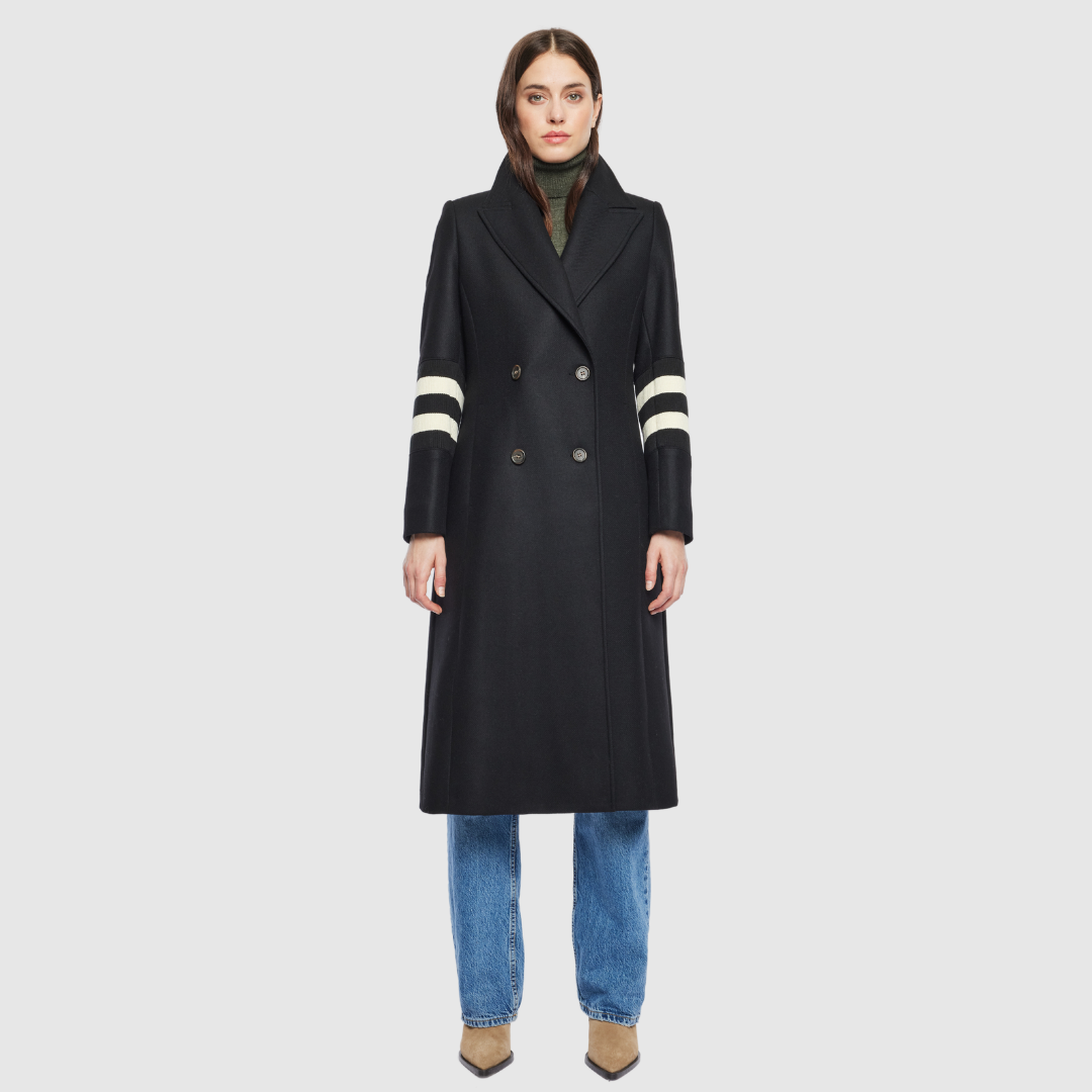 The YVETTE black wool is crafted from a luxurious Italian wool-cashmere blend, designed in a semi-fitted A-line silhouette that balances structure with ease. Its double-breasted closure and regular shoulder create a timeless, tailored line, while knit stripe detailing at the arms adds a subtle modern edge. Finished with a notch collar and functional slash pockets, YVETTE is a sophisticated outerwear piece that combines refinement with everyday versatility.