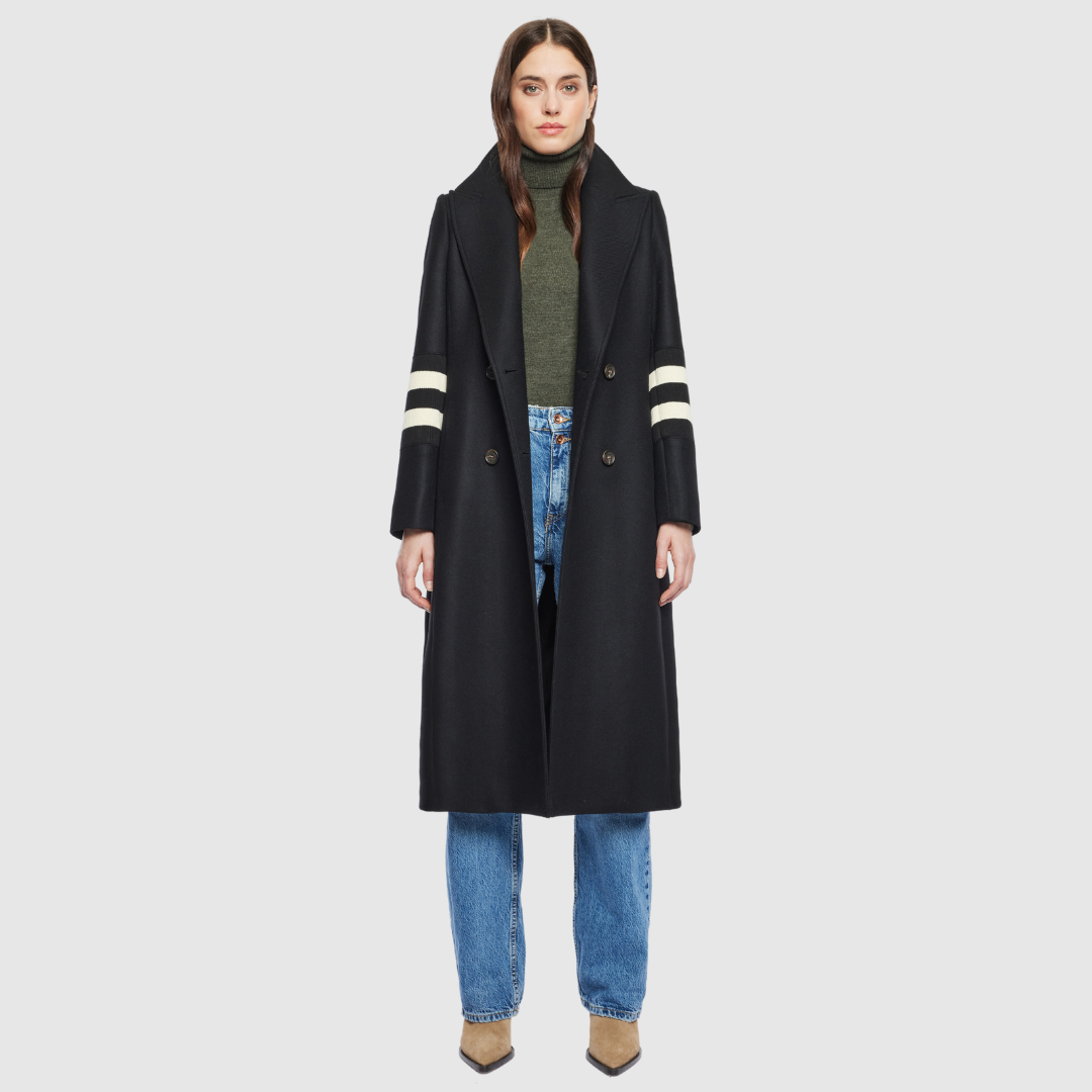 The YVETTE black wool is crafted from a luxurious Italian wool-cashmere blend, designed in a semi-fitted A-line silhouette that balances structure with ease. Its double-breasted closure and regular shoulder create a timeless, tailored line, while knit stripe detailing at the arms adds a subtle modern edge. Finished with a notch collar and functional slash pockets, YVETTE is a sophisticated outerwear piece that combines refinement with everyday versatility.