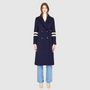 Italian wool cashmere blend Semi-fitted A-line silhouette Double breasted Regular shoulder Fitted through shoulders and arms, looser through torso Knit stripe detailing on arm Notch collar Slash pockets 