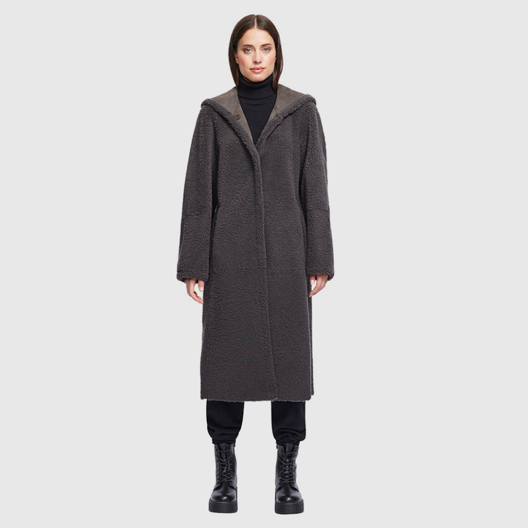 Reversible suede parka Reverses to a curly wool teddy Drop shoulder Fits comfortably through arms and torso Shawl collar with oversized hood Slash side pockets on both suede and curly wool side Snap button closure 