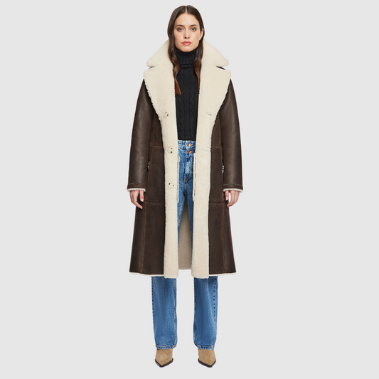 nappa curly wool shearling Vintage inspired reversible notch collar Reverses to curly wool teddy Relaxed dropped shoulder 3 button closure Tie belt at waist Zip pockets on nappa side, reverses to patch pockets on teddy side