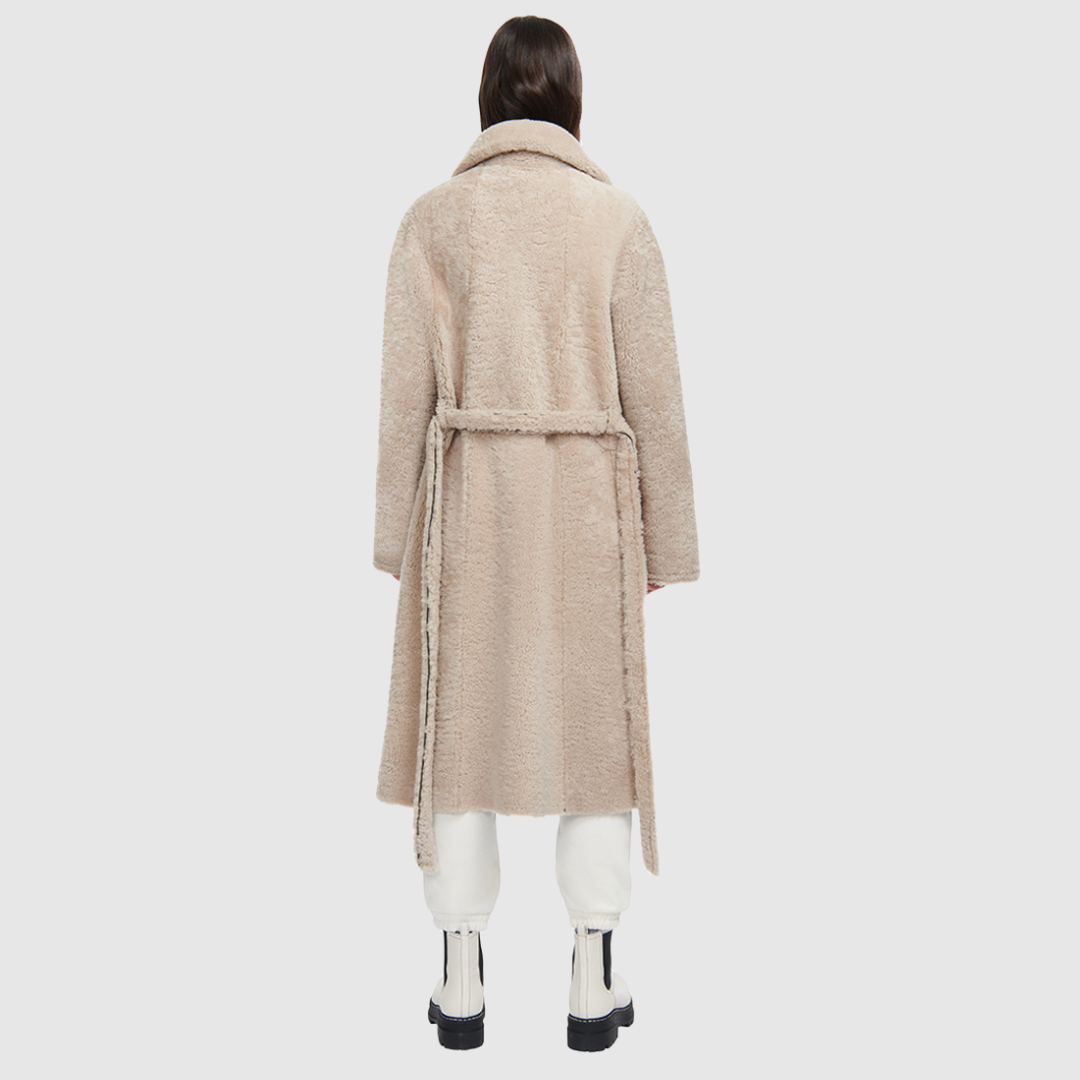nappa curly wool shearling Vintage inspired reversible notch collar Reverses to curly wool teddy Relaxed dropped shoulder 3 button closure Tie belt at waist Zip pockets on nappa side, reverses to patch pockets on teddy side