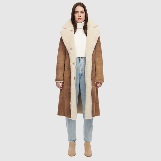 Suede curly wool shearling Vintage inspired reversible notch collar Reverses to curly wool teddy Relaxed dropped shoulder 3 button closure Tie belt at waist Zip pockets on suede side, reverses to patch pockets on teddy side