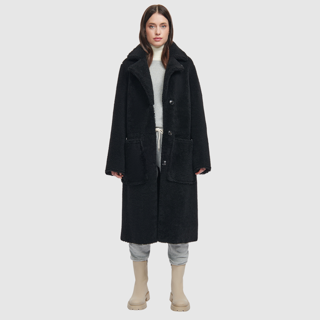 nappa curly wool shearling Vintage inspired reversible notch collar Reverses to curly wool teddy Relaxed dropped shoulder 3 button closure Tie belt at waist Zip pockets on suede side, reverses to patch pockets on teddy side