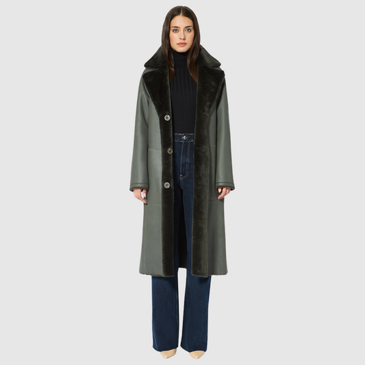 Nappa ironed wool shearling Vintage inspired reversible notch collar Reverses to ironed wool teddy Relaxed dropped shoulder 3 button closure Tie belt at waist on reversed side Zip pockets on nappa side, reverses to patch pockets on teddy side