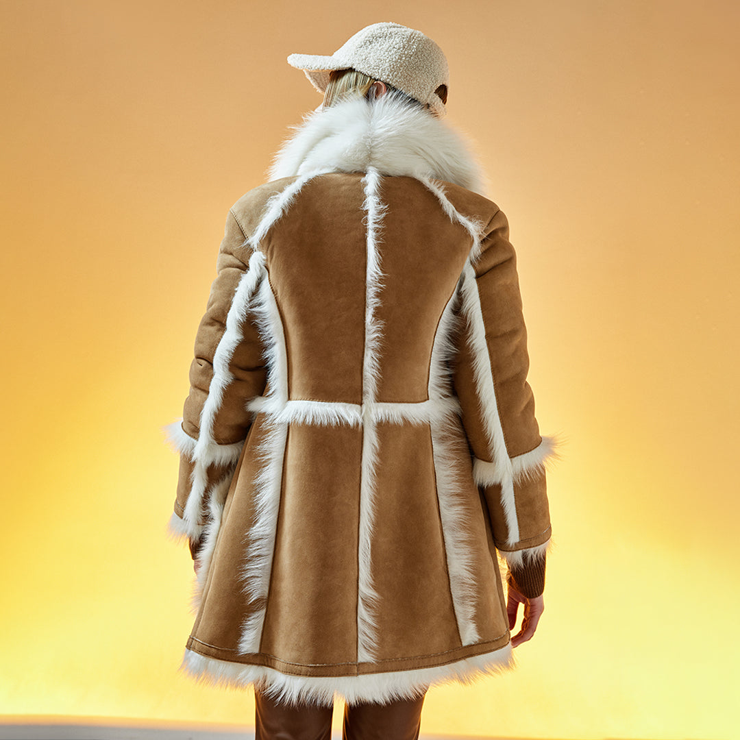 "This reversible contemporary coat provides timeless style.  On the city streets, you’ll be dressed for warmth in the Comet. Made from plush, insulating sheepskin, this button-front coat with fur-out trim keeps you cozy all winter long. Front patch pockets finish the design of this comfortable coat."