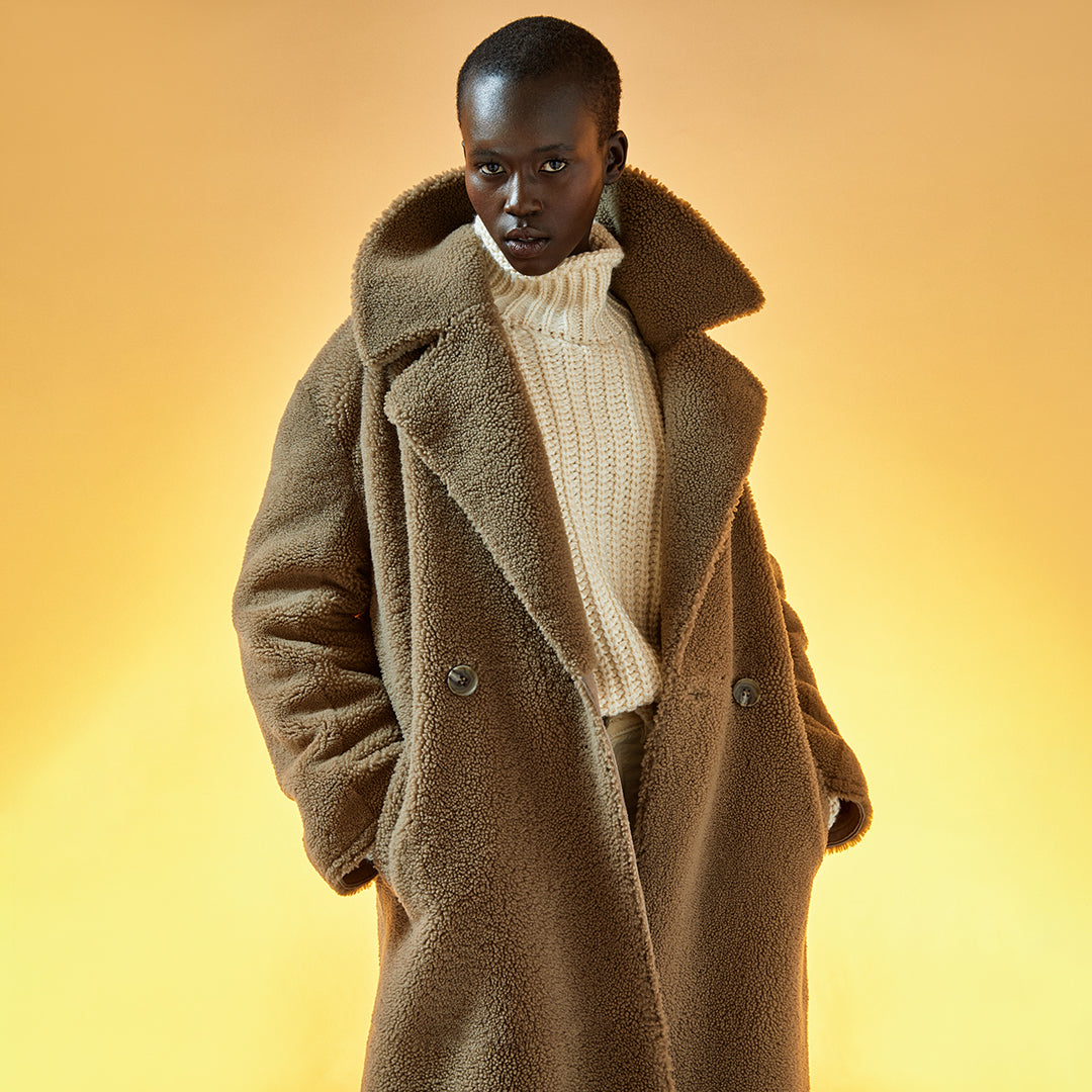 This notched collar coat is a fashionable layer for those cold days. Crafted from Spanish shearling this coat dresses you for days or evenings elegantly sheltering you from the cold with head-to-toe protection.