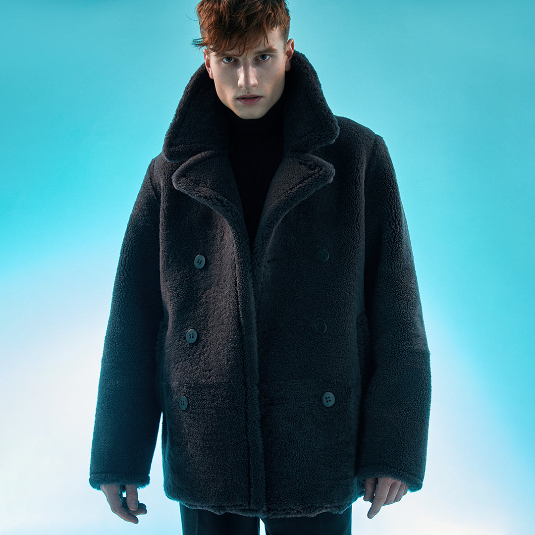 Medium length coat Looser fit  Raw edge finish 3 button closure This notched collar coat is a fashionable layer for those cold days. Crafted from Spanish shearling this coat dresses you for days or evenings elegantly sheltering you from the cold with head-to-toe protection.