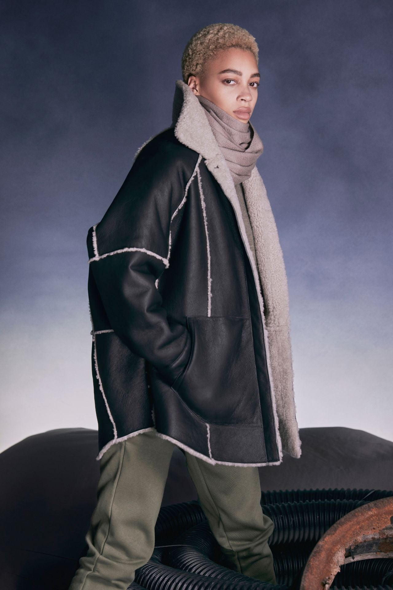 Reversible oversized suede shacket Reverses to curly wool teddy  Contrast curly wool seem detail  Drop shoulder Snap closure Oversized patch pockets