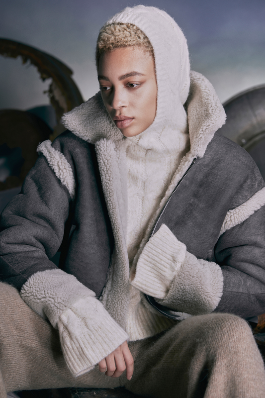 Dorian grey vintage white curly wool short shearling bomber. Reversible. Long sleeves with relaxed deep armhole. Pull through pockets. Ultralight 20 inch length. Raw edge finish Drop shoulder Pull through pockets