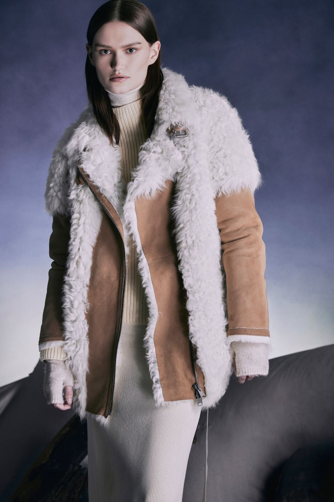 This stylish jacket is designed with an asymmetrical zip closure and waterfall collar. Crafted in genuine shearling, the jacket is finished with side zip pockets and double buckle detail at the collar. Genuine Shearling Waterfall collar Long-sleeve Zipper closure