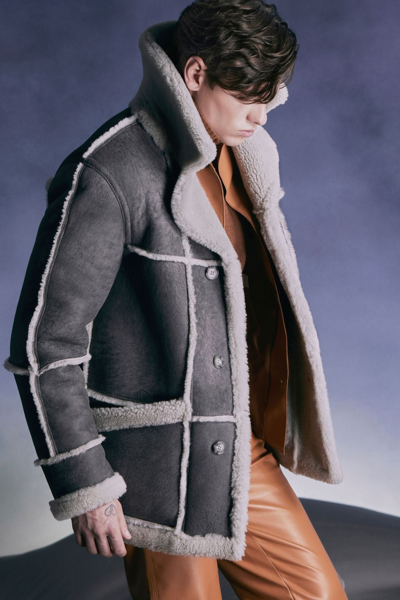 Experience luxury with Lyle, our designer mens shearling jacket in dorian Grey Vintage. Crafted from sheepskin with wool out detail, it's warm and stylish. True to size and reversible, it offers versatility in fit and style. Featuring a notch lapel and interior zipper pockets, front patch pockets, this 46" inch coat combines comfort with sophistication for winter coat perfection.