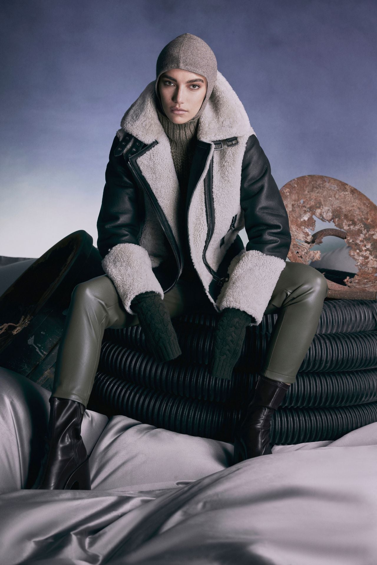 Soul womenƒ??s jacket ƒ?? a fusion of designer elegance and winter warmth. Crafted from curly wool on a sleek nappa moto base, this coat boasts a drop shoulder silhouette for a relaxed fit. The sheared wool body and sleeves provide cozy insulation, while the curly wool collar adds a touch of luxury with its double buckle detail. The asymmetrical front zip closure exudes modern flair, and practicality is ensured with side and interior zip pockets. Elevate your outerwear game this winter!