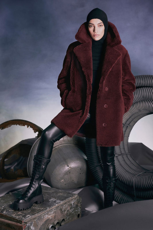 This burgundy suede curly notched collar coat is a fashionable layer for those cold days. Crafted from Spanish shearling this coat dresses you for days or evenings elegantly sheltering you from the cold with head-to-toe protection..