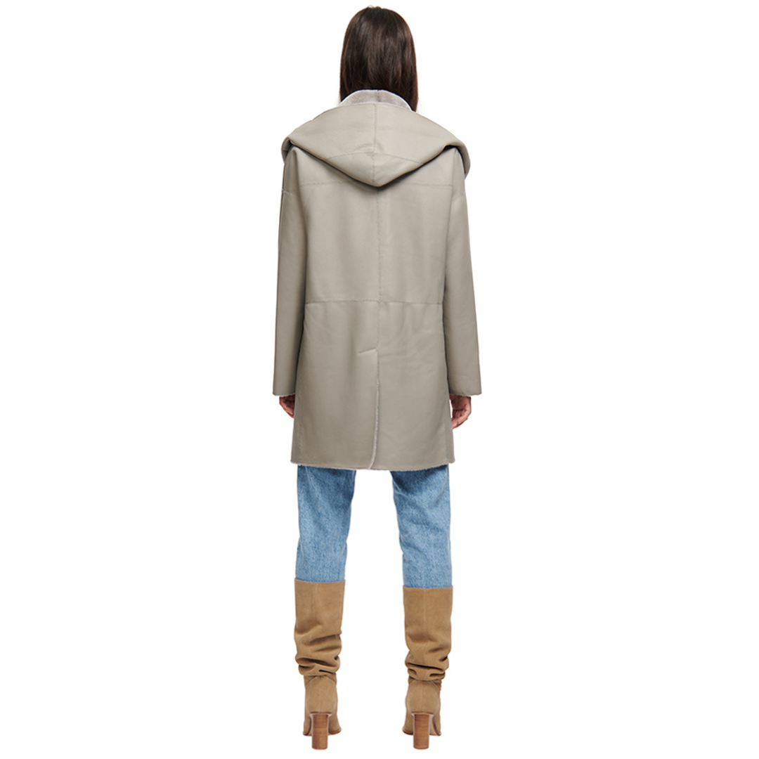 Reversible nappa oversized coat Reverses to ironed wool teddy Oversized hood, converts to shawl collar Raw edge finish Drop shoulder Button closure Pull through pocket